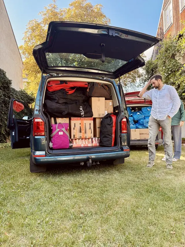 An open van packed tightly with luggage and trip supplies.